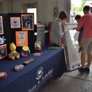 Kids are playing our Plinko game at a touch-a-truck event.