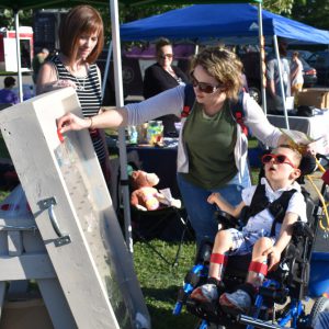 A young boy and his mom play Plinko